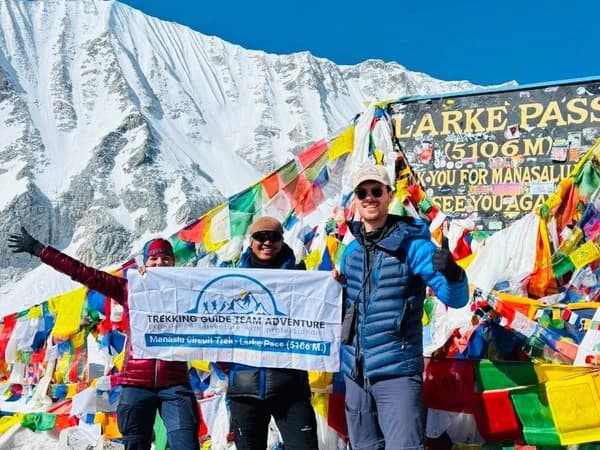 Trekkers celebrating at Larke Pass (5,106m) on the Manaslu Circuit Trek