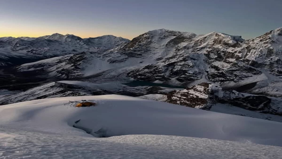 Sunset view over the Khumbu peaks and a turquoise glacial lake from Lobuche East high camp